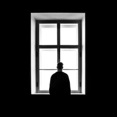 Man Standing In Window